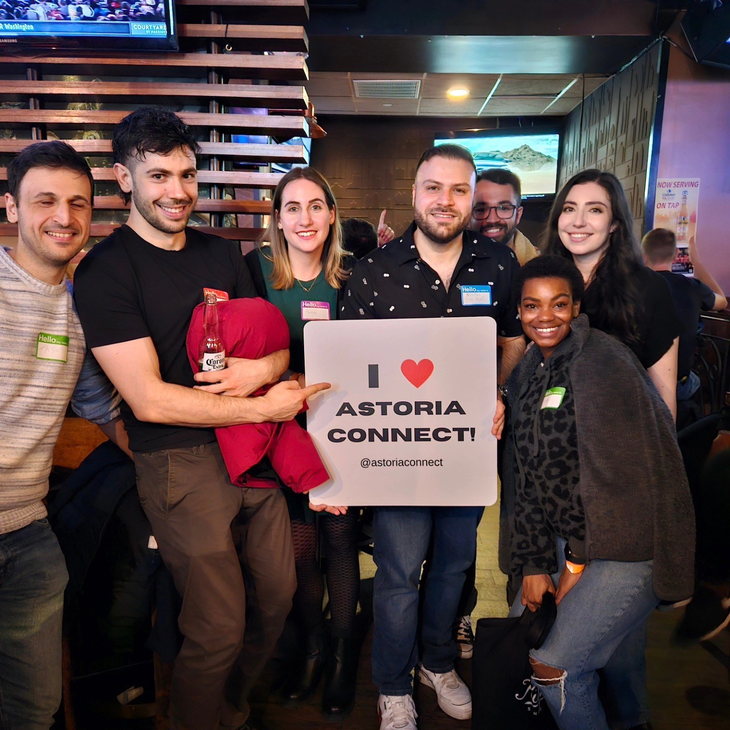 Friends holding an I love Astoria Connect sign
